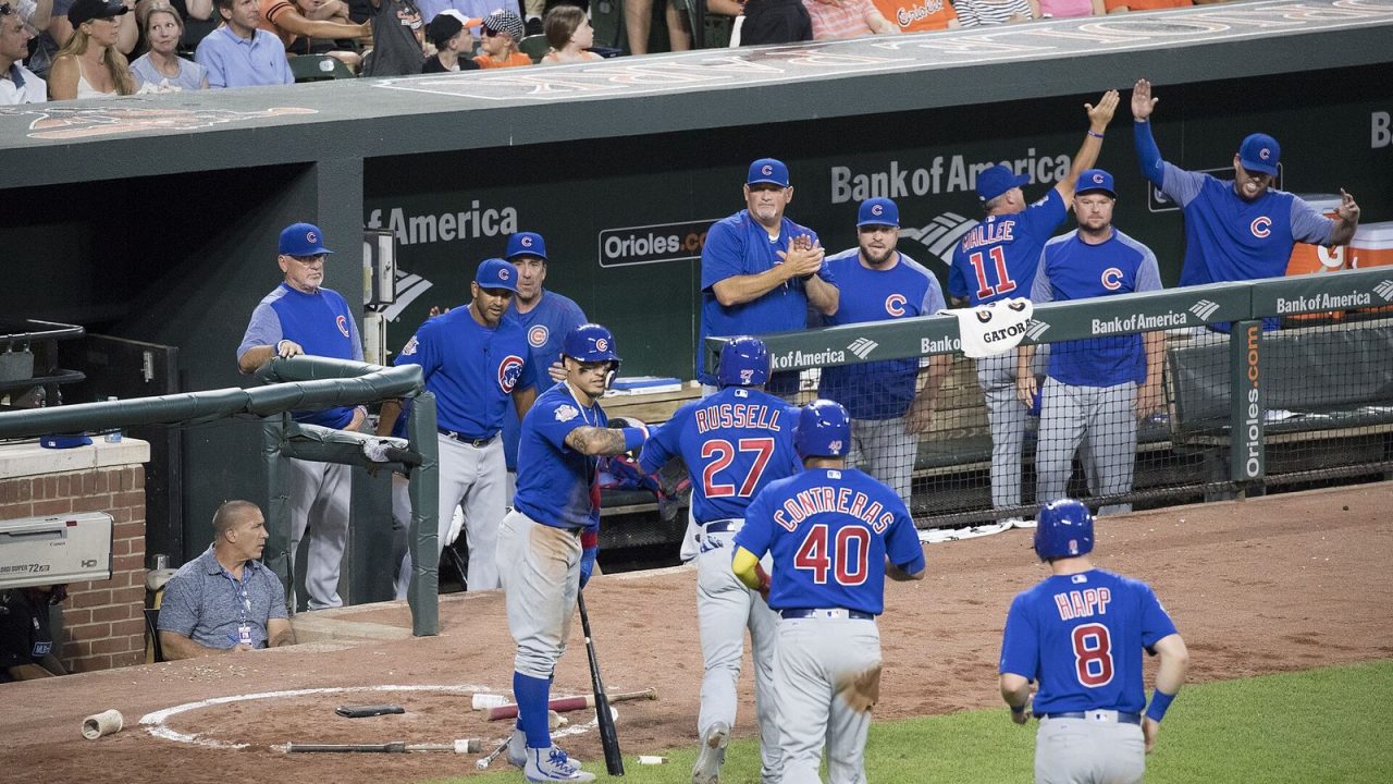 Chicago Cubs players and coaches watching from the dugout during a 2017 game at Camden Yards