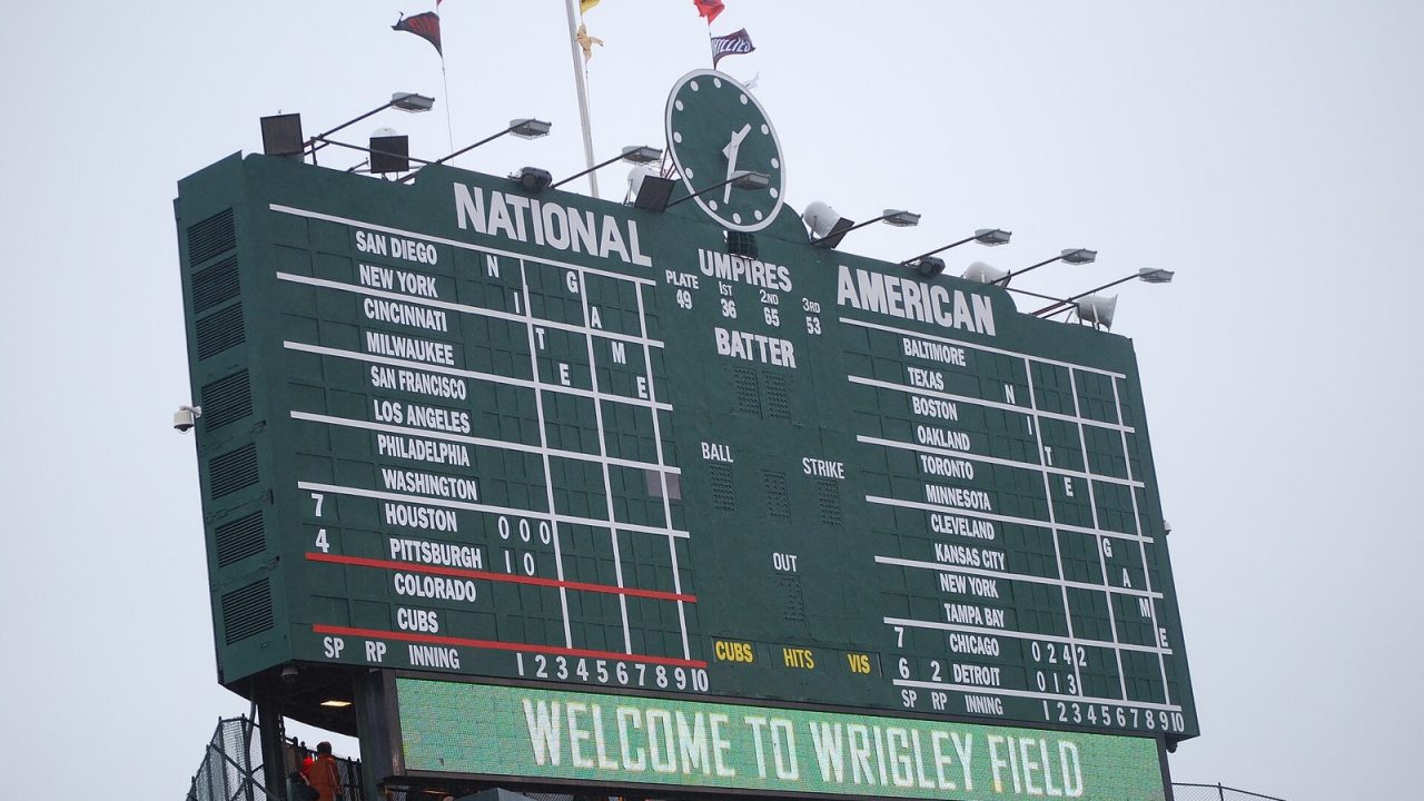 Wrigley Field's hand-operated center field scoreboard showing inning-by-inning line scores