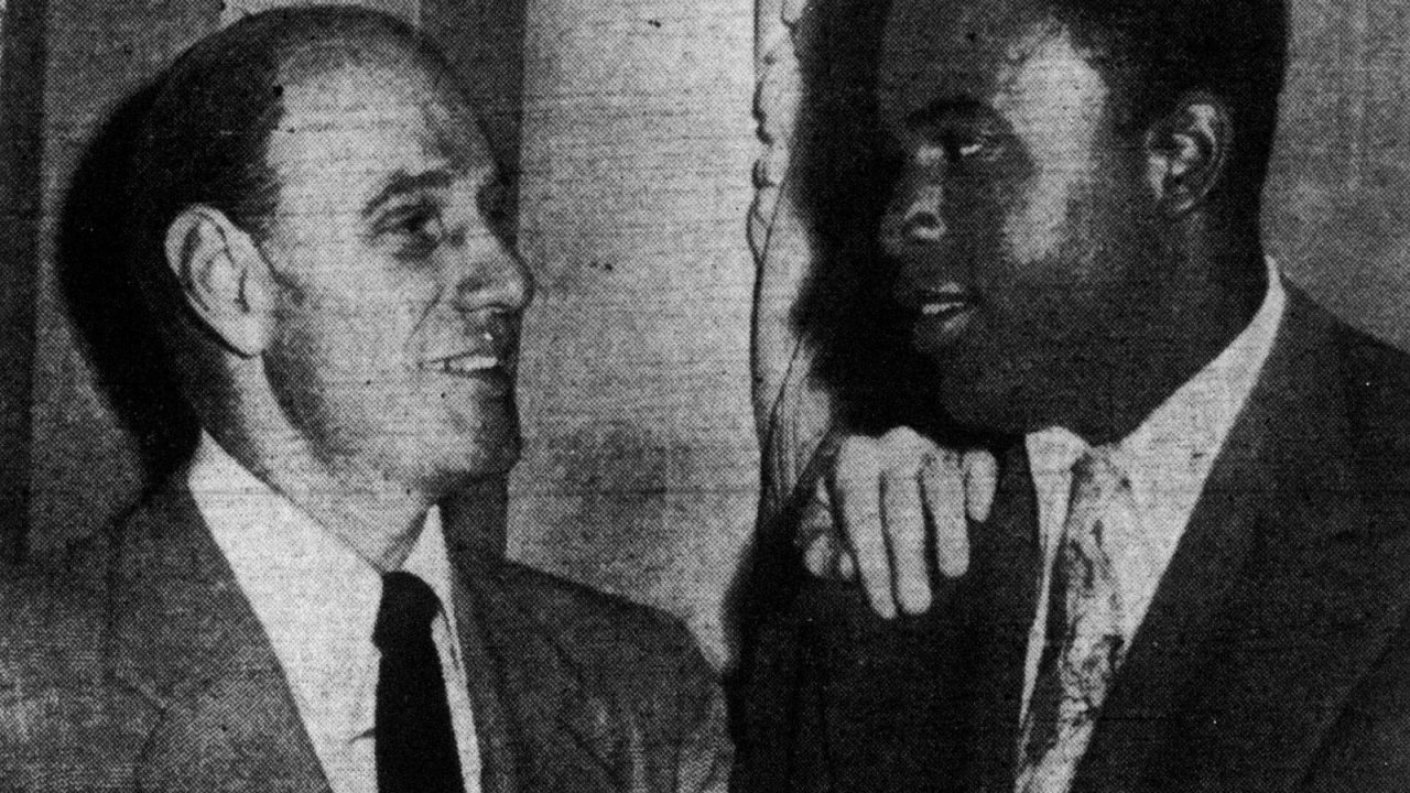 Brooklyn Dodgers manager Leo Durocher standing beside Jackie Robinson in 1947