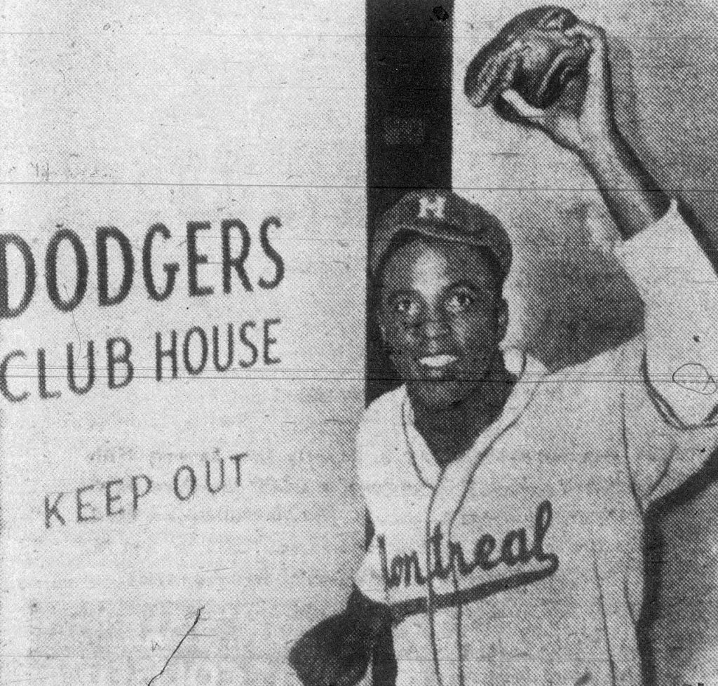 Jackie Robinson, still in a Montreal Royals uniform, entering the Brooklyn Dodgers clubhouse in April 1947